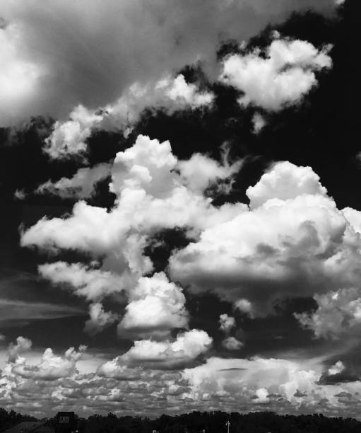 istock Grayscale shot of puffy cumulus clouds 1440769925