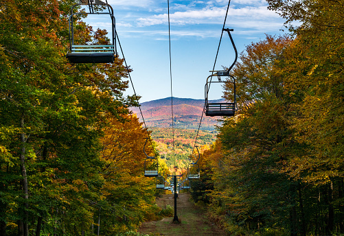 View down Mount Mansfield with ski lift chairs leading down the hillside in Vermont autumn image