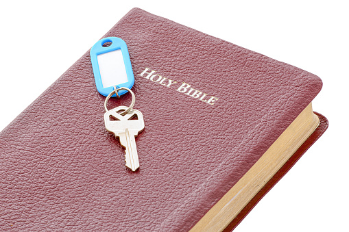 Key attached to a key holder on the Holy Bible