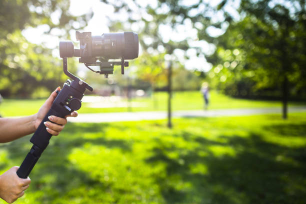 istock A girl operating camera mounted on a gimbal, focus on the gimbal and camera. 1440775028