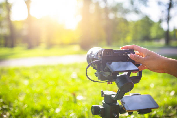 istock A girl operating camera mounted on a gimbal, focus on the gimbal and camera. 1440775101