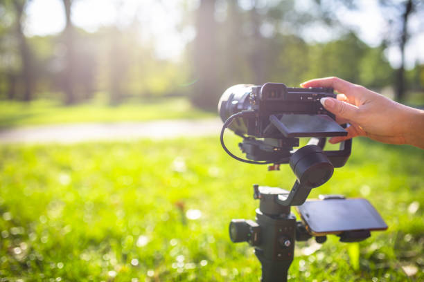 istock A girl operating camera mounted on a gimbal, focus on the gimbal and camera. 1440775248