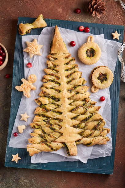 Christmas tree shape puff pastry pie with spinach, garlic and cheese, and puff pastry Linzer Christmas tree toys