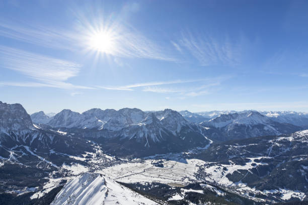 Beautiful winter day in the mountains. Tirol, Austria View from top of a mountain to the valley of Ehrwald at a beautiful day in winter. Wild snowy alpine landscape with sun and blue sky. Tirol, Austria ehrwald stock pictures, royalty-free photos & images