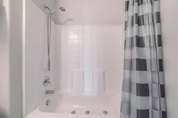 istock Bathtub with shower and open curtains in a white bathroom 1440776678