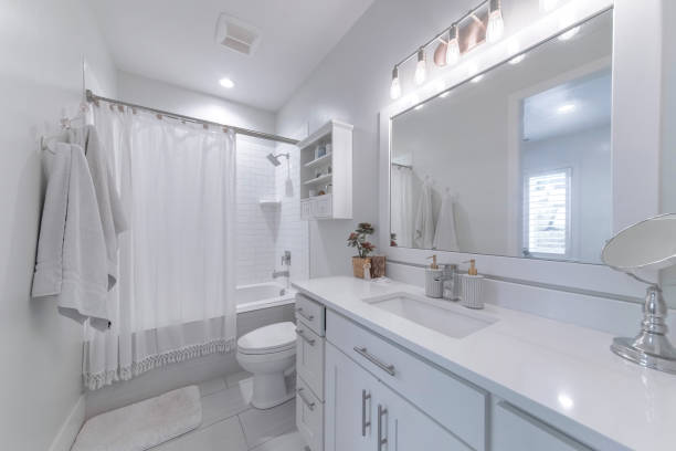 istock Mirror, a sink, and a bath with a closed curtain in a bathroom 1440776854