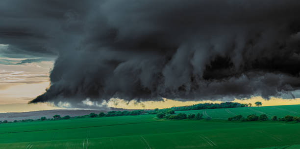 istock Green field with thunderous black clouds hanging low over it just before a tornado 1440777469