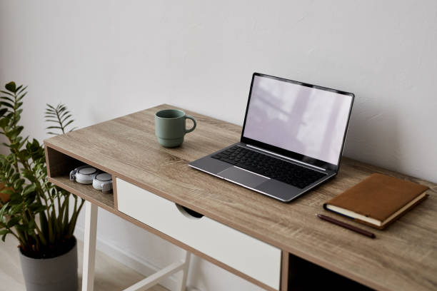 istock Workplace of student, freelancer or online tutor with laptop, notebook and cup 1440777574