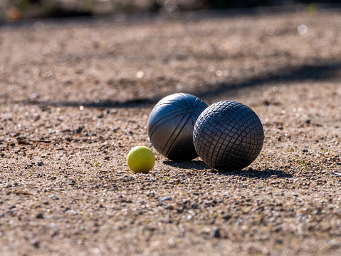A closeup shot of petanque balls on the ground