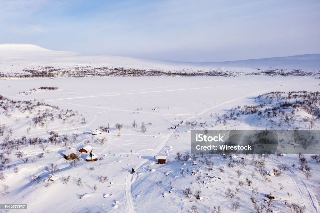 Aerial view of lake Tshahkajarvi, sunny day, in Lapland - rising, drone shot Aerial view of lake Tshahkajarvi, sunny, winter day, in Kilpisjarvi, Lapland Above Stock Photo