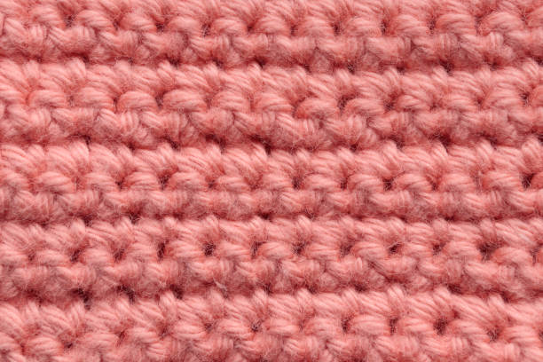 istock Crochet handmade square pattern, knitting crocheting top view on a wooden background 1440778302