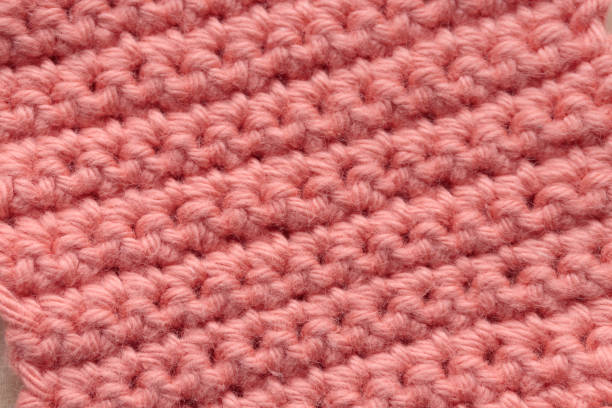 Closeup Macro Crochet handmade square pattern, knitting crocheting top view on a wooden background with a copyspace