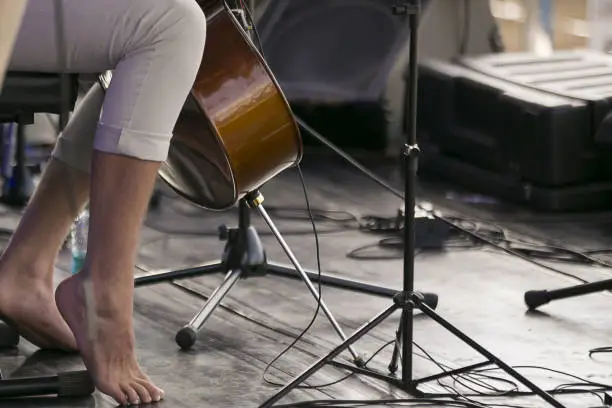 cello player with bare feet on stage