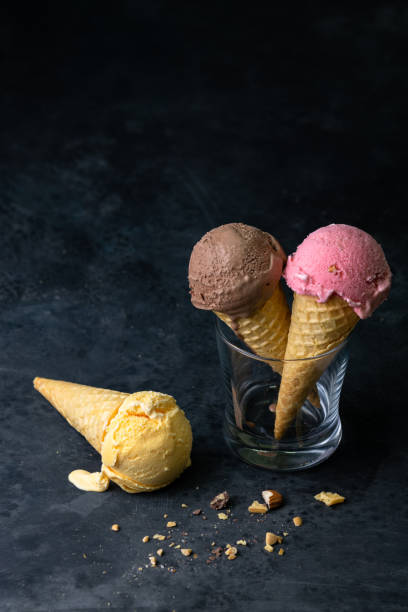 istock Vertical shot of ice cream isolated on a dark background 1440778513