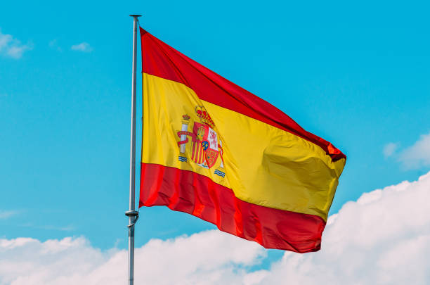 istock Shot of a Spanish flag on blue sky background 1440778782