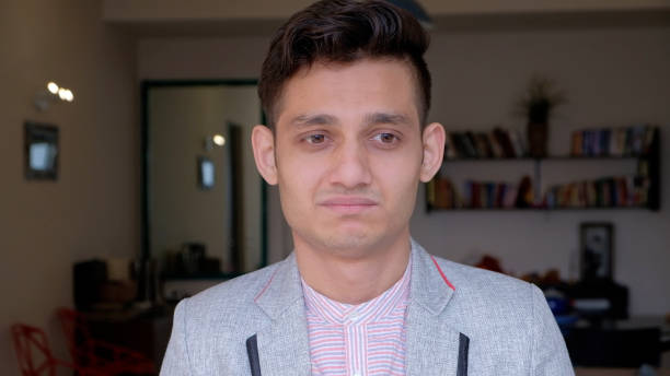 istock Handsome Indian man in a suit looking at the camera with a serious face 1440779570