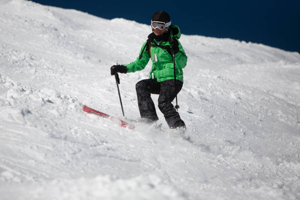 istock Expert mature woman skier on a steep bumpy slope. 1440779692