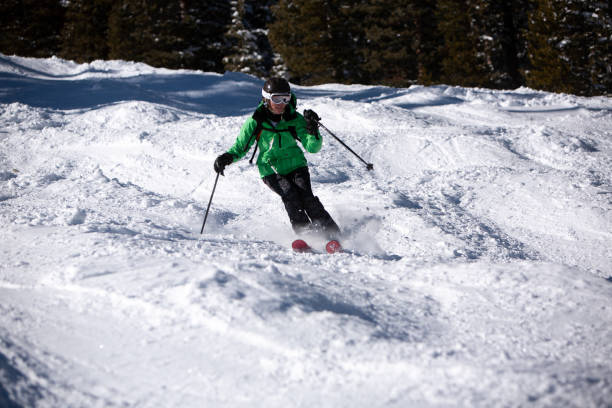 istock Expert mature woman skier on a steep bumpy slope. 1440779704