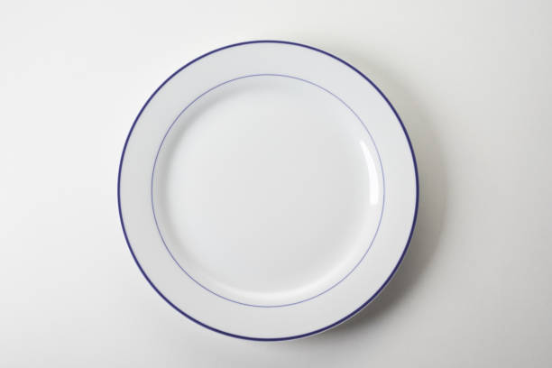 istock Top view of a ceramic plate with a brown brim for lunch on white background 1440781647