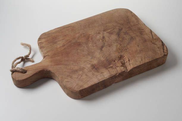 istock Brown wooden kitchen hot dish trivet or a chopping board with a handle on white background 1440781671