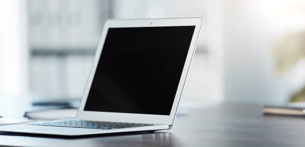istock Digital, laptop and black screen mock up on table surface in office building for marketing, design and frame. Desktop, monitor and online with creative mockup on empty or blank pc display on desk 1440781702