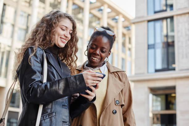istock Two Young Women Using Smartphone in City 1440781962