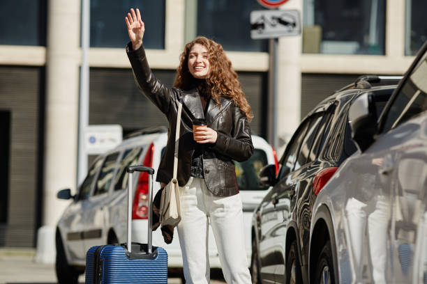 istock Smiling Young Woman Hailing Cab 1440782067