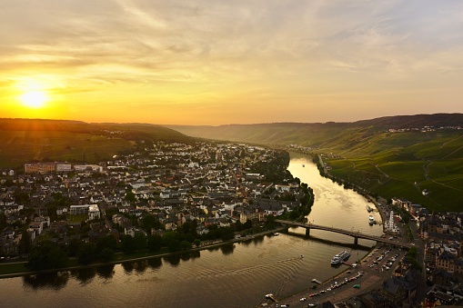 Sunset on the Moselle River. The winding silat of the river at sunset. The curved Moselle River at sunset. Vineyards on the slopes of the Moselle River at sunset.