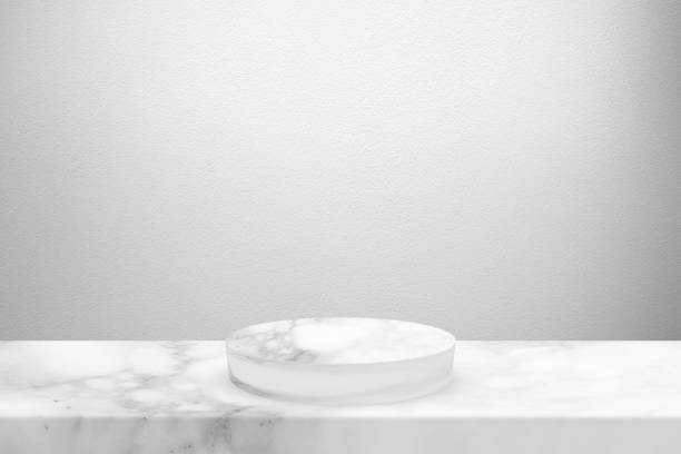istock White Marble Cylinder Podium on the Table and Concrete Wall Background with Spot Light from the Top, Suitable for Product Presentation Backdrop, Display, and Mock up. 1440782339