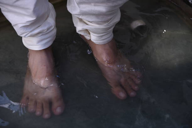 Indian groom in water stream Standing in feet deep in fresh  water and , groom  are seen cleaning his leg ritual sikh walking in water stock pictures, royalty-free photos & images