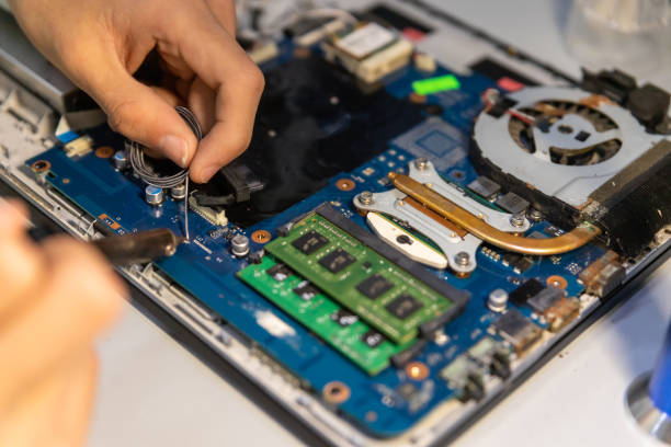istock Computer repair technician repairing a laptop 1440783003