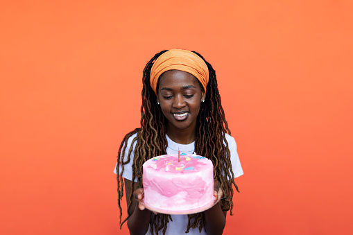 Young Black woman with birthday cake