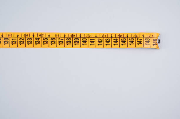 Diet concept. Orange juice and measuring tape