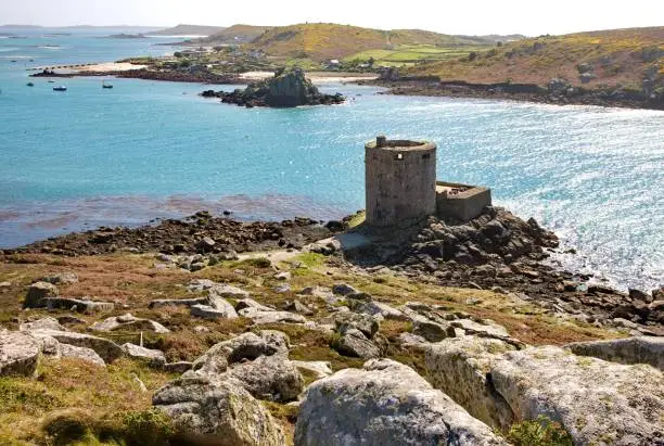 The Cromwell's Castle surrounded by water under the sunlight in the Isles of Scilly, England