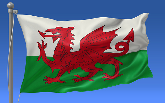 Wales flag waving on the flagpole on a sky background
