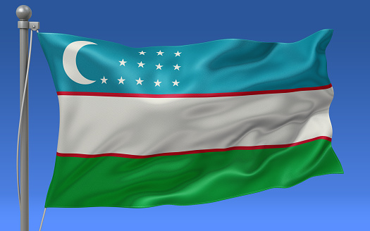 Uzbekistan flag waving on the flagpole on a sky background
