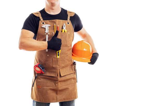 istock Contractor worker or carpenter in apron with tools and helmet holding thumbs up 1440786711