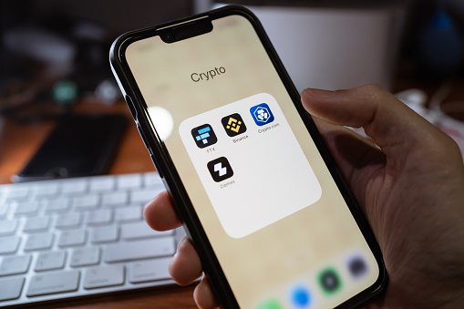 Bangkok, Thailand - November 11, 2022 : iPhone 13 showing its screen with FTX, Binance, Crypto.com, Zipmex, popular cryptocurrency trading applications.