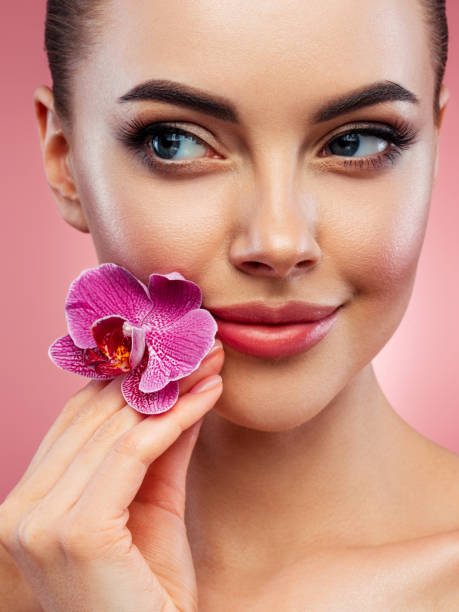 istock Beautiful woman holding flower 1440788498