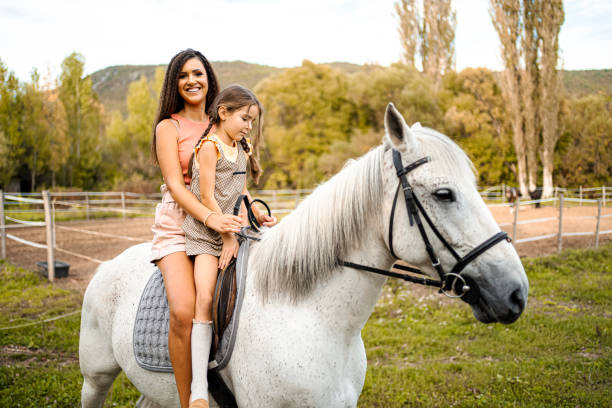 istock Mother teaching her daughter to ride a horse 1440788537