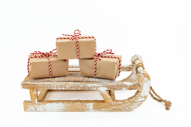 istock A wooden sleigh with three gifts 1440789082