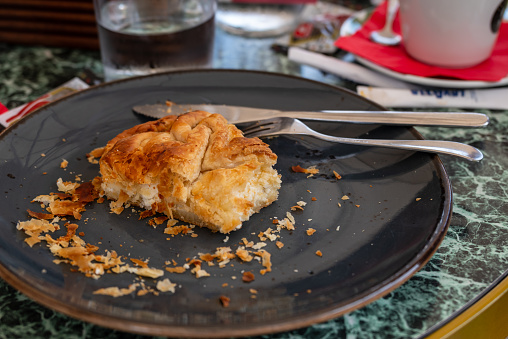 Bougatsa Classic Greek Cypriot dessert made from filo pastry and vanilla-spiced semolina cream or feta cheese, image from Nymfaio Greece.
Selective focus.
