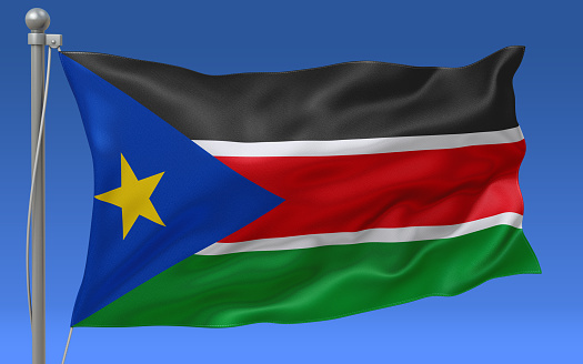 South Sudan flag waving on the flagpole on a sky background