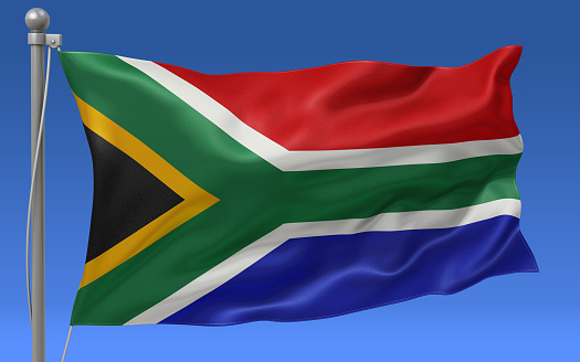 South Africa flag waving on the flagpole on a sky background