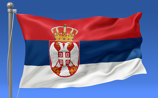 Serbia flag waving on the flagpole on a sky background