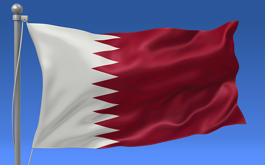 Qatar flag waving on the flagpole on a sky background