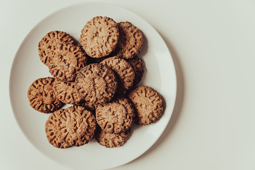 Homemade whole wheat biscuits heap on white background