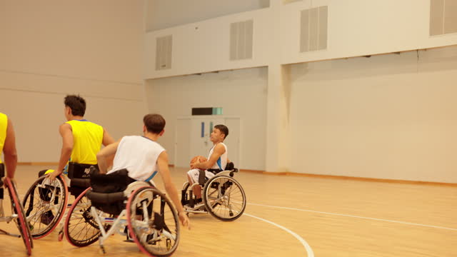 Disabled sport men in action playing basketball.