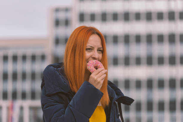 istock Eating donut outdoors in the city 1440796504