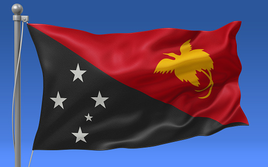 Papua New Guinea flag waving on the flagpole on a sky background